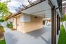 Covered outdoor patio featuring a pergola-style roof structure, recessed lighting, ceiling fan, and painted concrete flooring