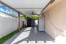 Covered patio featuring a concrete floor, recessed lighting, and a ceiling fan, enclosed by a white vertical fence