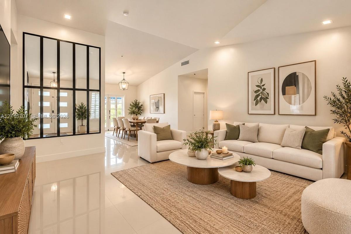 Vaulted ceilings, polished tile flooring, recessed lighting, and a prominent black-framed glass wall partition
