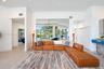 Open-concept interior featuring large-format tile flooring, recessed ceiling lighting, a ceiling fan, and sliding glass doors revealing an outdoor poo