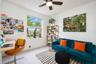Light-filled room featuring neutral tile flooring, a large window, and an integrated ceiling fan with light fixture