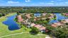 Aerial perspective featuring a waterfront property with an in-ground swimming pool and direct proximity to a golf course