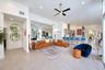 Open-concept interior featuring large-format tile flooring, recessed ceiling lighting, a contemporary ceiling fan, and a kitchen island with integrate