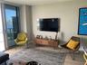 Floor-to-ceiling sliding glass door, neutral interior paint, and wood-finish flooring