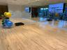 Fitness studio featuring wood-finish flooring, floor-to-ceiling mirrored walls, recessed lighting, and wall-mounted display monitors