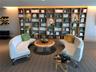 Full-wall floor-to-ceiling wooden built-in shelving with integrated recessed lighting and textured wall coverings