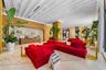 Expansive lobby featuring a coffered ceiling, terrazzo flooring, wood-paneled walls, and a built-in reception desk