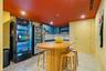 Built-in cabinetry with integrated shelving, matte-finish square tile backsplash, metallic sink faucet, and stone-finish tile flooring - building amen