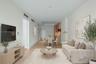 Open-concept interior featuring light wood-finish flooring, recessed lighting, and a modern kitchen with flat-panel cabinetry - staged