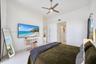 High-ceilinged room featuring neutral tile flooring, a brushed-nickel ceiling fan, and large windows with prominent natural light