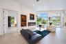Living area featuring large-format tile flooring, recessed lighting, a linear electric fireplace, and floor-to-ceiling glass sliding doors