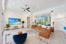 Living area featuring high ceilings, large-format tile flooring, recessed lighting, ceiling fan, and expansive sliding glass doors