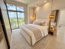 Floor-to-ceiling windows, large-format tile flooring, built-in floor-to-ceiling cabinetry, dual pendant lighting, and an exterior balcony with railing