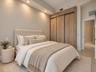 Built-in floor-to-ceiling wood-finish closet system, recessed ceiling lighting, and smooth-finish concrete flooring