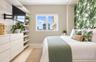 Built-in shelving unit, cabinetry with light wood-finish, and window with exterior cityscape