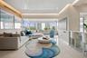 High-gloss finish ceiling with recessed accent lighting, expansive floor-to-ceiling windows, polished stone flooring, and custom built-in cabinetry