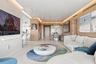 High-gloss ceiling with integrated perimeter recessed lighting, polished stone flooring, and warm wood-panel wall treatments