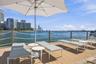 Waterfront wood-finish deck featuring a rope-rail perimeter