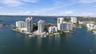 Aerial perspective of a waterfront peninsula featuring high-rise residential towers, deep-water dockage, and expansive maritime frontage