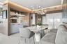 Custom built-in cabinetry with integrated lighting and stone surfacing, complemented by light-toned wood-finish wall paneling, high-gloss cabinetry, a
