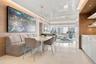 High-gloss ceiling with recessed perimeter lighting, wall-to-wall wood-finish paneling, custom built-in cabinetry with stone-finish countertops, and l