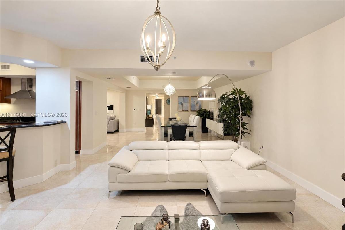 Open floor plan featuring tile flooring, recessed lighting, and a spherical metal chandelier