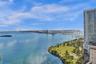 High-altitude coastal scenery featuring expansive water, distant bridge infrastructure, and coastal landmass