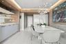 Built-in wet bar with illuminated shelving, integrated cabinetry, wood-finish wall paneling, ceiling recessed lighting, and a modern sculptural pendan
