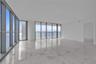 Floor-to-ceiling windows, polished stone flooring, and metal-framed exterior railing