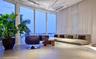 Floor-to-ceiling windows featuring expansive glass panels, large-format tile flooring, recessed ceiling lighting, and a tiered platform structure
