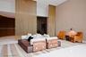 Metallic chain-link room dividers, recessed ceiling lighting, curved wood-paneled walls, and geometric patterned wall texture