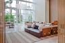 Double-height floor-to-ceiling windows, polished stone flooring, and contemporary suspended multi-tiered chandelier