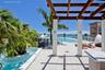 Rooftop terrace featuring a wooden pergola, swimming pool with glass railing, stone-finish tiling, and built-in stone-top counter
