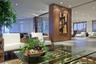 Wood-paneled structural column, polished stone flooring, recessed ceiling lighting, and decorative metal room partition
