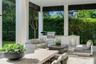 Covered outdoor patio featuring an integrated kitchen with a stainless steel built-in grill, stone-finish countertops, and under-counter storage, fram
