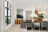 Large-format windows with black metal frames, recessed lighting, and dual textured pendant fixtures