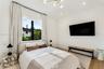 Wood-finish flooring, multi-light modern chandelier, recessed lighting, and large windows featuring black frames