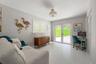 Glossy tile flooring, double glass-paneled exterior doors, plantation shutters, and a ceiling-mounted drum light fixture