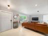 Living space featuring large-format tile flooring, recessed lighting, and a built-in window seat