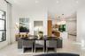 Open-concept interior featuring large-format tile flooring, recessed ceiling lighting, and a gourmet kitchen equipped with a waterfall-edge stone isla
