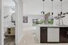 Kitchen island featuring dark cabinetry, quartz countertop, and integrated sink