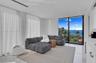 Floor-to-ceiling glass sliding doors, polished stone flooring, recessed ceiling lighting, and expansive water exposure