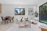 Open-concept living space featuring wood-finish flooring, recessed lighting, and large sliding glass doors providing outdoor access