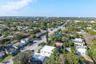 Aerial perspective of an established neighborhood featuring mature tree canopy, varied residential density, paved thoroughfares, and proximity to regi