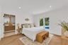 Herringbone-patterned wood-finish flooring, recessed lighting, and glass-paned double doors with exterior pool access