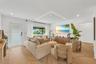 Living area featuring light-toned herringbone patterned flooring, recessed ceiling lighting, a recessed rectangular architectural ceiling detail with 