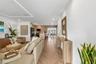 Herringbone wood-finish flooring, recessed ceiling lighting, linear architectural cove lighting, kitchen island with built-in cabinetry, and integrate
