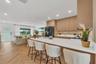 Kitchen featuring flat-panel wood cabinetry, white countertops, a gold-toned faucet, herringbone wood-finish flooring, and recessed ceiling lighting