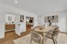 Herringbone wood-finish flooring, recessed lighting, and crisp white wall finish