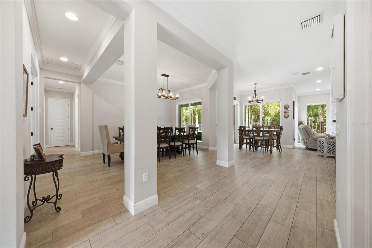 Formal dining open to home yet defined as an elegant space